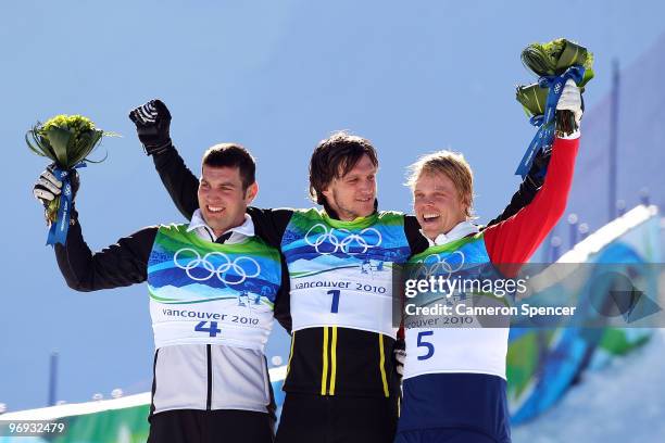 Andreas Matt of Austria celebrates winning silver, Michael Schmid of Switzerland gold and Audun Groenvold of Norway bronze during the flower ceremony...