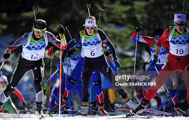 Germany's Simone Hauswald , France's Marie Laure Brunet and Norway's Ann Kristin Aafedt Flatand compete during the women's Biathlon 12.5 km mass...