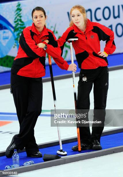 Melanie Robillard and Stella Heiss of Germany react after losing to Denmark during the women's curling round robin game between Denmark and Germany...
