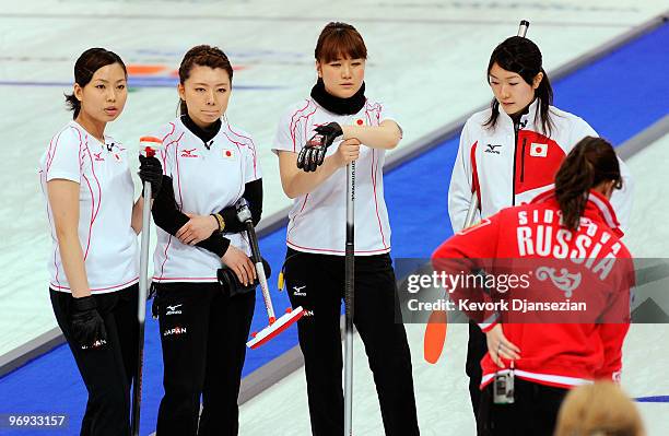 Anna Ohmiya , Moe Meguro , Mayo Yamaura and Mari Motohashi of Japan look on during a time out against Russia during the women's curling round robin...