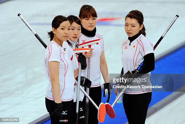 Anna Ohmiya , Moe Meguro , Mayo Yamaura and Mari Motohashi of Japan look on during a time out against Russia during the women's curling round robin...