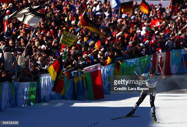 Magdalena Neuner of Germany skies to the line to claim gold in the women's biathlon 12.5 km mass start on day 10 of the 2010 Vancouver Winter...
