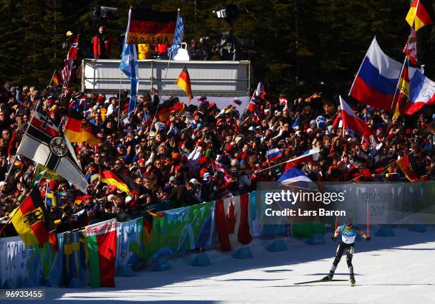 Magdalena Neuner of Germany skies to the line to claim gold in the women's biathlon 12.5 km mass start on day 10 of the 2010 Vancouver Winter...