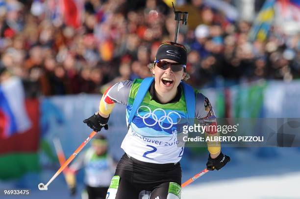 Germany's gold medalist Magdalena Neuner reacts as she finishes in the women's Biathlon 12.5 km mass start final at the Whistler Olympic Park during...