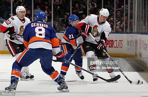 Filip Kuba of the Ottawa Senators skates against Kyle Okposo of the New York Islanders on February 14, 2010 at Nassau Coliseum in Uniondale, New York.