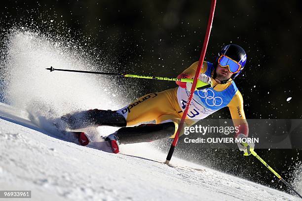 Canada's Tyler Nella clears a gate during the Men's Vancouver 2010 Winter Olympics Super Combined event at Whistler Creek side Alpine skiing venue on...