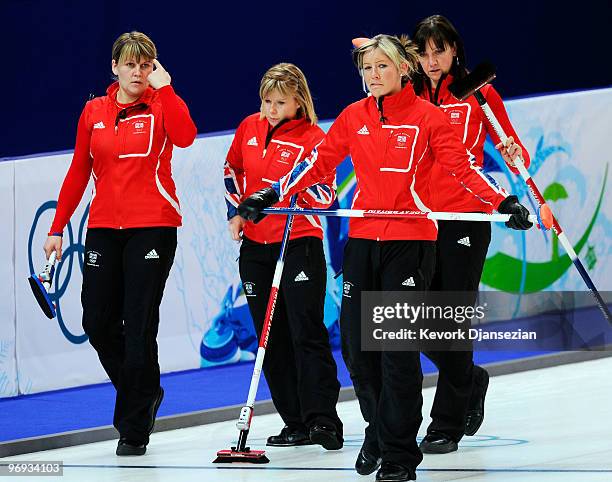 Eve Muirhead of Great Britain and Northern Ireland and her teammates Lorna Vevers, Kelly Woods and Jackie Lockhart react after losing to Switzerland...