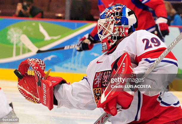 Czech goal keeper Tomas Vokoun tries to block the puck during the Men's preliminary Ice Hockey match Russia against Czech at the XXI Winter Olympic...
