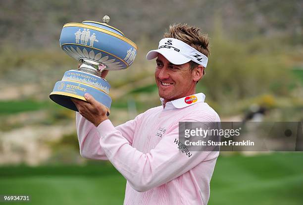 Ian Poulter of England lifts the Walter Hagen Cup throphy on the 16th hole after winning the final round of the Accenture Match Play Championship at...
