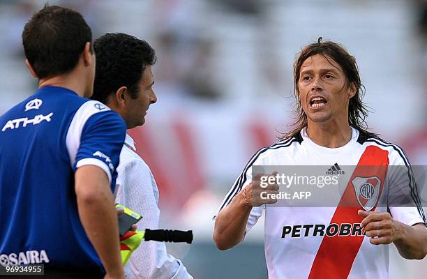 River Plate's Matias Almeyda argues with linesman Sergio Viola next to his coach Leonardo Astrada after he was sent off from the game during their...