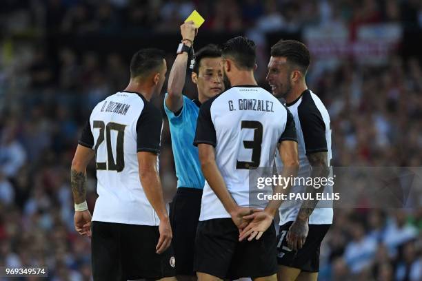 Costa Rica's defender Giancarlo Gonzalez is shown a yellow card by Japanese referee Hiroyuki Kimura during the International friendly football match...