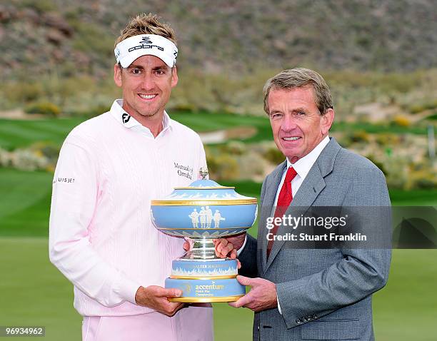 Ian Poulter of England holds the trophy with Tim Finchem, Commissioner of the PGA TOUR after winning the Accenture Match Play Championship at the...