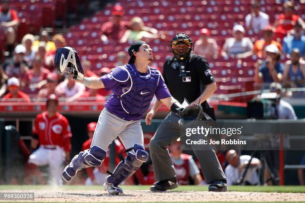 Tony Wolters of the Colorado Rockies looks around for the ball after a wild pitch by Wade Davis allowed the tying run to score in the ninth inning...