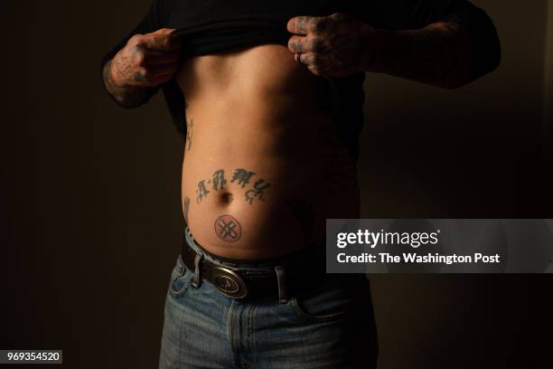 April 26: Chris Buckley shows a KKK tattoo in his home in LaFayette, Ga., on Thursday, April 26, 2018. Chris Buckley, a former member of the KKK and...