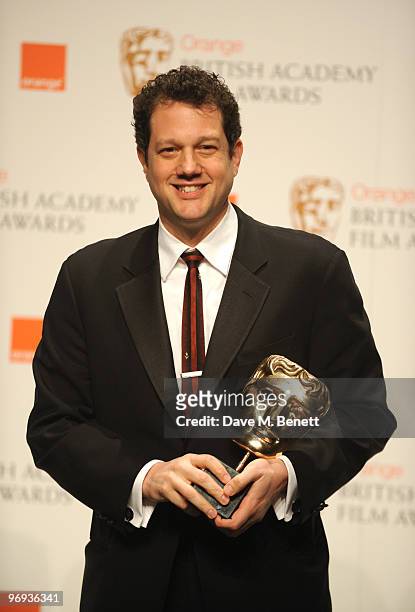 Michael Giacchino poses with the Best Music Award for Up during the The Orange British Academy Film Awards 2010 at The Royal Opera House on February...