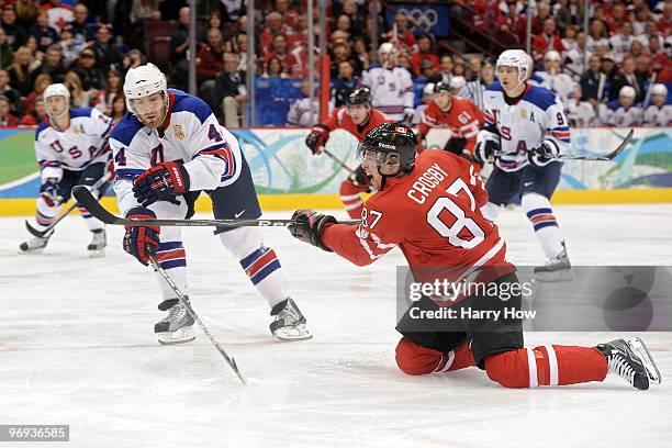 Sidney Crosby takes a shot next to Tim Gleason of the United States during the ice hockey men's preliminary game between Canada and USA on day 10 of...