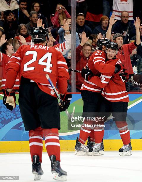 Eric Staal of Canada celebrates with his team mates after he scored during the ice hockey men's preliminary game between Canada and USA on day 10 of...