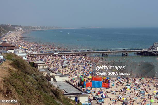 General view of an overcrowded Bournemouths beach during a hot summer day. Bournemouth is a famous tourist attraction in south of England . During...