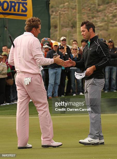 Ian Poulter of England is congratulated by fellow countryman Paul Casey on the 16th hole after winning the final round of the Accenture Match Play...