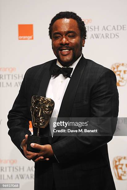 Lee Daniels poses with the award he accepted on behalf of Mo'nique for her Supporting Actress role in the film Precious during the The Orange British...