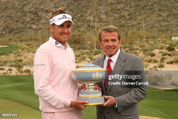 Ian Poulter of England holds the trophy with Tim Finchem, Commissioner of the PGA TOUR after winning the Accenture Match Play Championship at the...