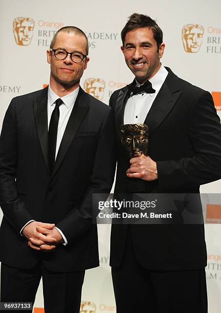 Sheldon Turner poses with the Adapted Screenplay Award for Up In The Air presented by Guy Pearce during the The Orange British Academy Film Awards...