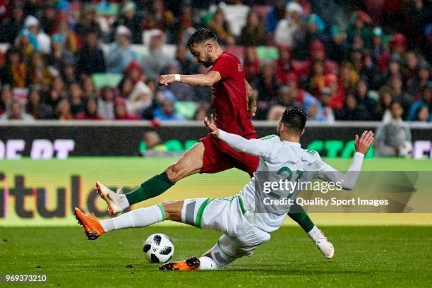 Rami Bensebaini of Algeria competes for the ball with Bruno Fernandes of Portugal during the friendly match of preparation for FIFA 2018 World Cup...