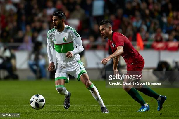 Riyad Mahrez of Algeria beats Raphael Guerreiro of Portugal during the friendly match of preparation for FIFA 2018 World Cup between Portugal and...