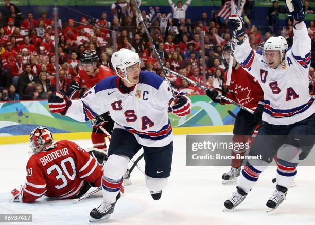 Jamie Langenbrunner of the United States celebrates after his team mate Brian Rafalski scored during the ice hockey men's preliminary game between...