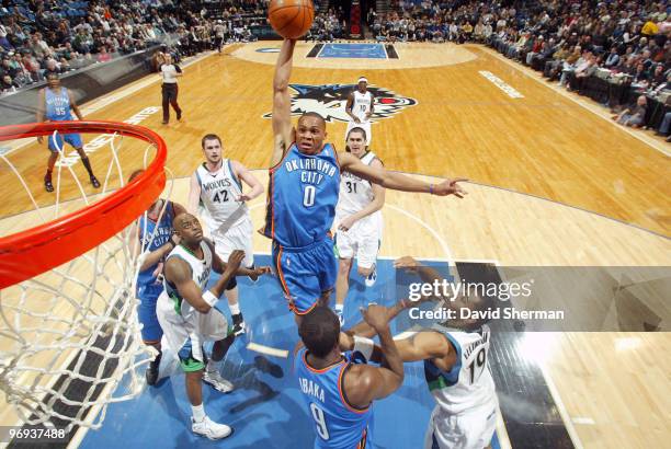 Russell Westbrook of the Oklahoma City Thunder dunks against Damien Wilkins and Wayne ellington of the Minnesota Timberwolves during the game on...