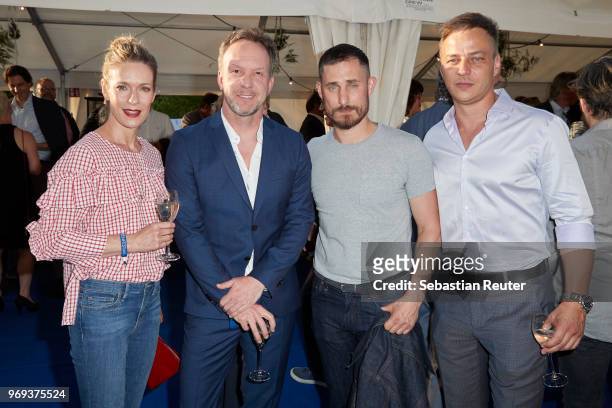 Actress Lisa Martinek, a guest, actors Clemens Schick and Tom Wlaschiha attend the summer party 2018 of the German Producers Alliance on June 7, 2018...
