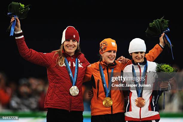 Kristina Groves of Canada celebrates winning silver, Ireen Wust of Netherlands gold and Martina Sablikova of Czech Republic bronze during the medal...