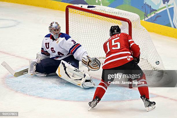 Dany Heatley of Canada scores past goalkeeper Ryan Miller of the United States during the ice hockey men's preliminary game between Canada and USA on...