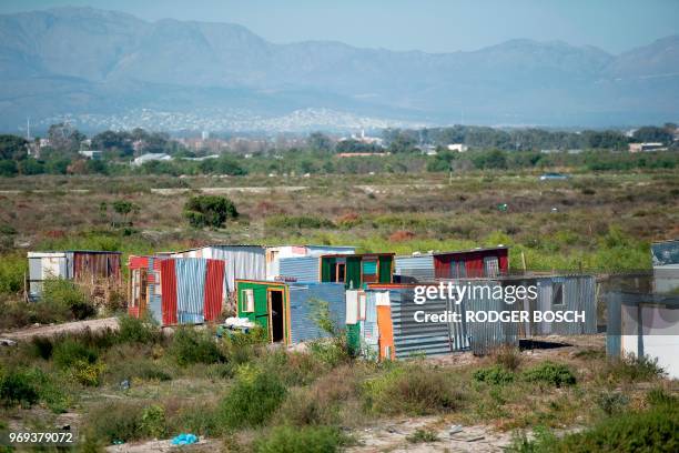 Picture taken on May 17, 2018 shows huts, built with sheets of metals, in the makeshift illegally established and informal settlement in Khayelitsha,...