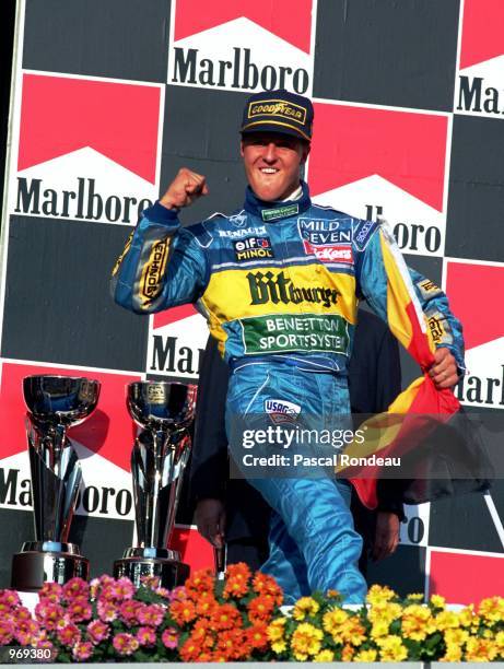 Benetton driver Michael Schumacher of Germany celebrates on the podium after winning the Pacific Formula One Grand Prix held at the T1 Circuit, in...