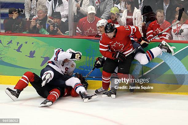Ryan Suter of the United States falls on top of Sidney Crosby of Canada as Brenden Morrow of Canada attempts to push off of Dustin Brown of the...