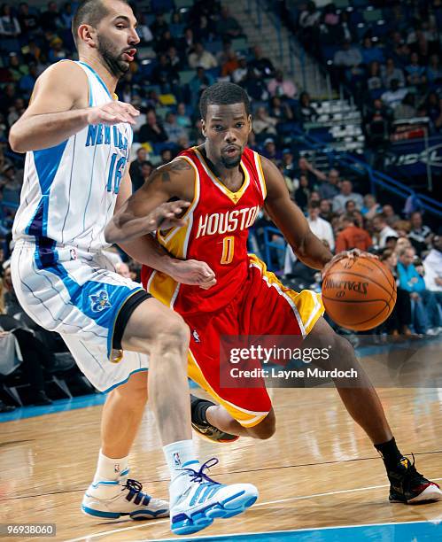 Aaron Brooks of the Houston Rockets drives around Peja Stojakovic of the New Orleans Hornets on February 21, 2010 at the New Orleans Arena in New...