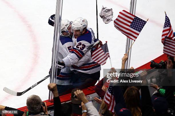 Chris Drury of the United States celebrates with his team mate after he scored during the ice hockey men's preliminary game between Canada and USA on...