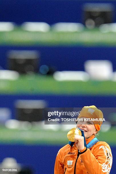 Gold medallist, Netherlands' Ireen Wust, celebrates on the podium during the medal ceremony after competing in the Ladies' 1500m speedskating race at...