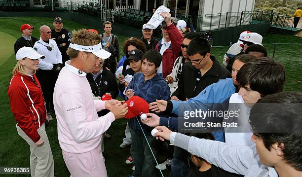 Ian Poulter of England signs autographs for fans after his win of the final round of the World Golf Championships-Accenture Match Play Championship...