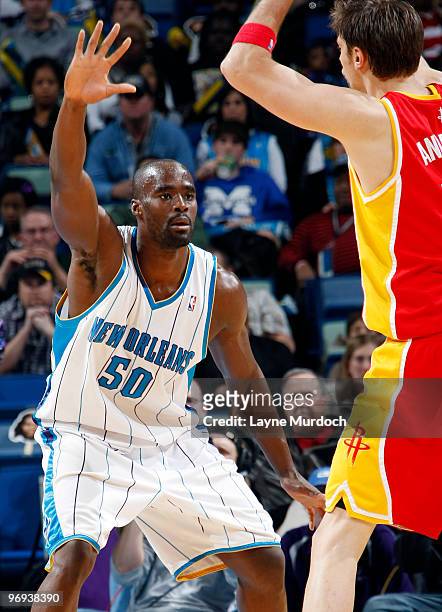 Emeka Okafor of the New Orleans Hornets guards David Andersen of the Houston Rockets on February 21, 2010 at the New Orleans Arena in New Orleans,...