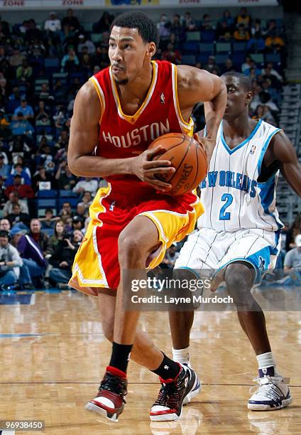 Garrett Temple of the Houston Rockets drives past Darren Collison of the New Orleans Hornets on February 21, 2010 at the New Orleans Arena in New...