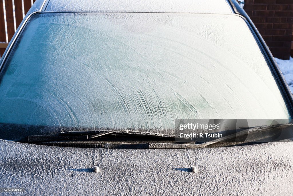 Frosty patterns on a completely covered car windscreen