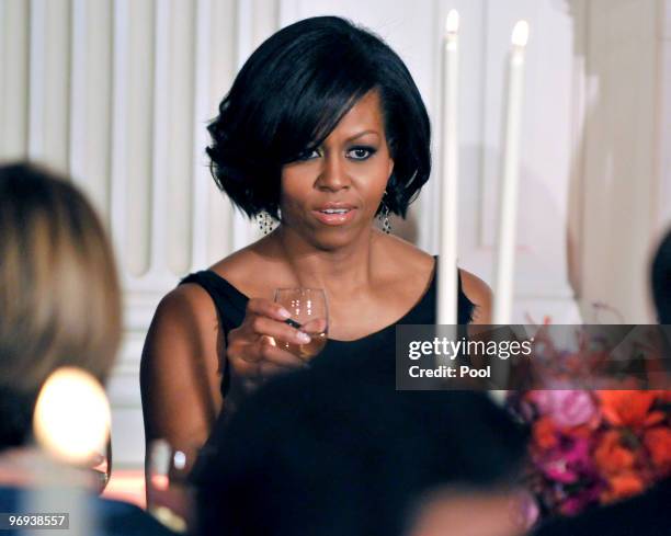 First lady Michelle Obama raises her glass during the White House Governors Ball in the State Dining Room on February 21, 2010 in Washington, DC. The...