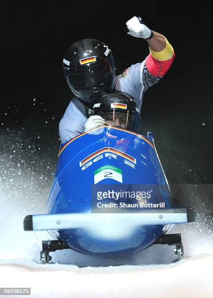 Germany 2 with Thomas Florschuetz and Richard Adjei celebrate their silver medal during the Two-Man Bobsleigh Heat 4 on day 10 of the 2010 Vancouver...