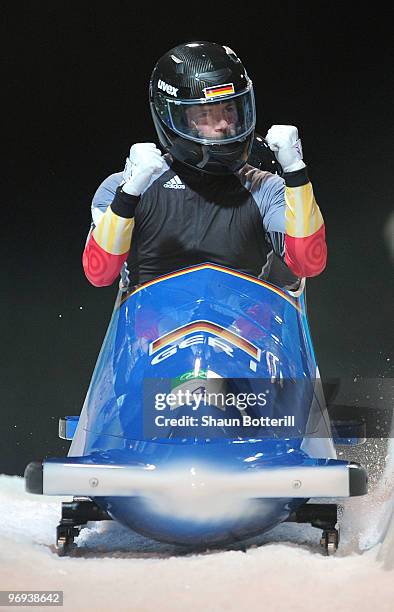 Germany 1 with Andre Lange and Kevin Kuske of Germany celebrate their gold medal during the Two-Man Bobsleigh Heat 4 on day 10 of the 2010 Vancouver...