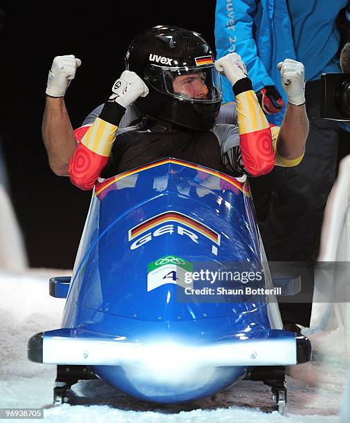 Germany 1 with Andre Lange and Kevin Kuske of Germany celebrate their gold medal during the Two-Man Bobsleigh Heat 4 on day 10 of the 2010 Vancouver...