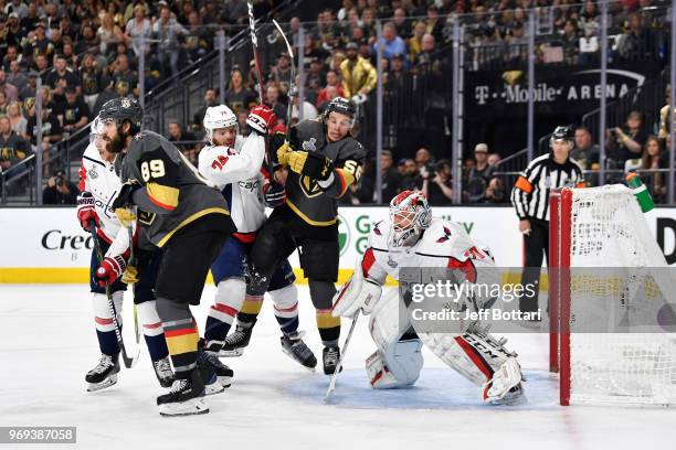 John Carlson of the Washington Capitals checks Erik Haula of the Vegas Golden Knights in front of goaltender Braden Holtby during the first period in...