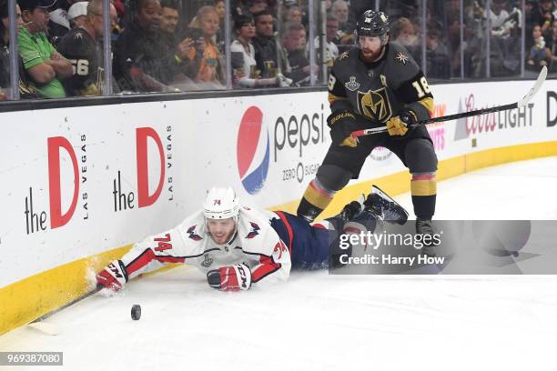John Carlson of the Washington Capitals attempts to control the puck against James Neal of the Vegas Golden Knights during the first period in Game...