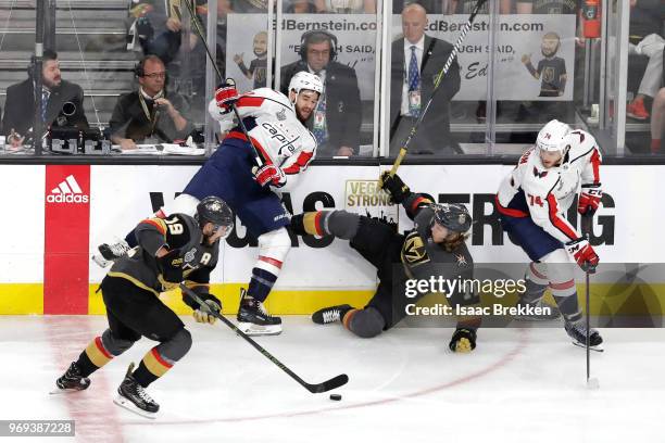 John Carlson of the Washington Capitals defends James Neal of the Vegas Golden Knights as William Karlsson falls to the ice during the first period...